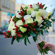 White roses, ranunculus and red hypericum berry bride bouquet 